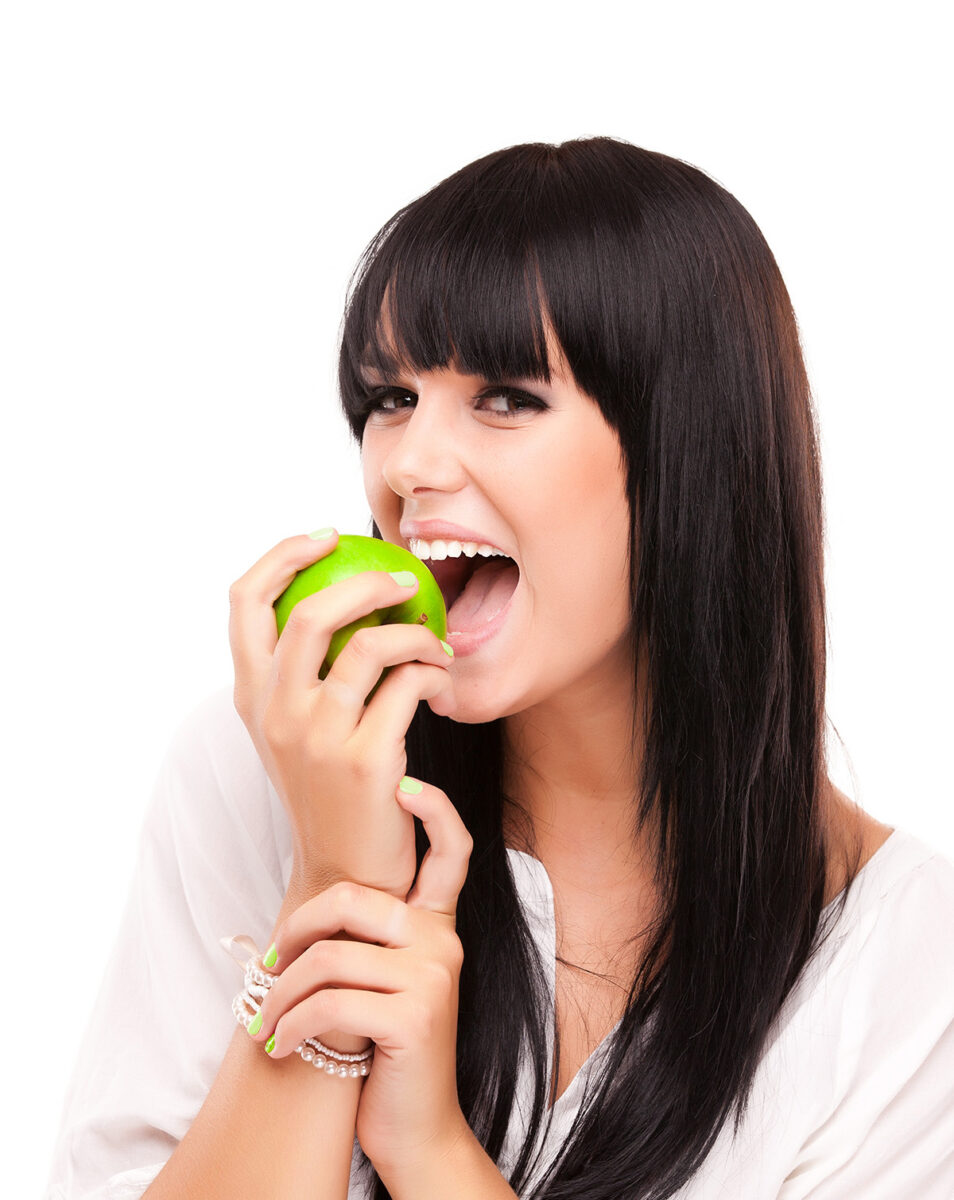 young woman eating an apple
