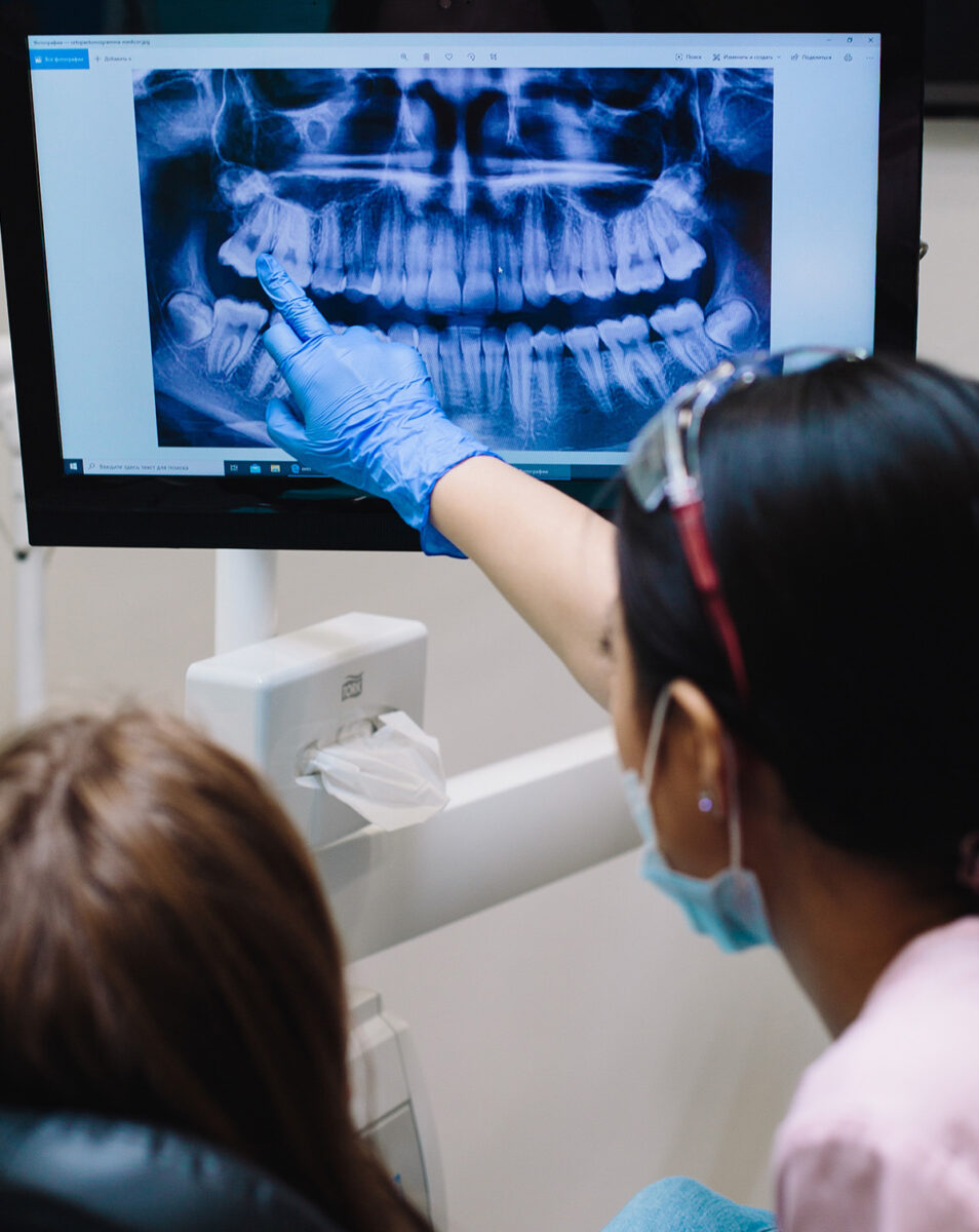 dentist and patient looking at xray